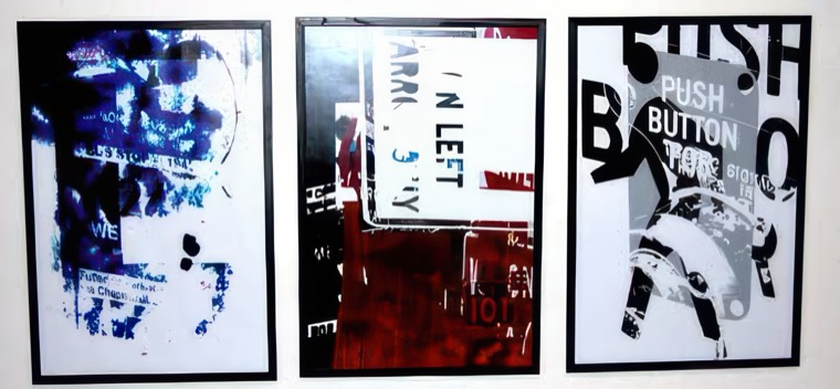 Three of the poster designs mounted on a wall