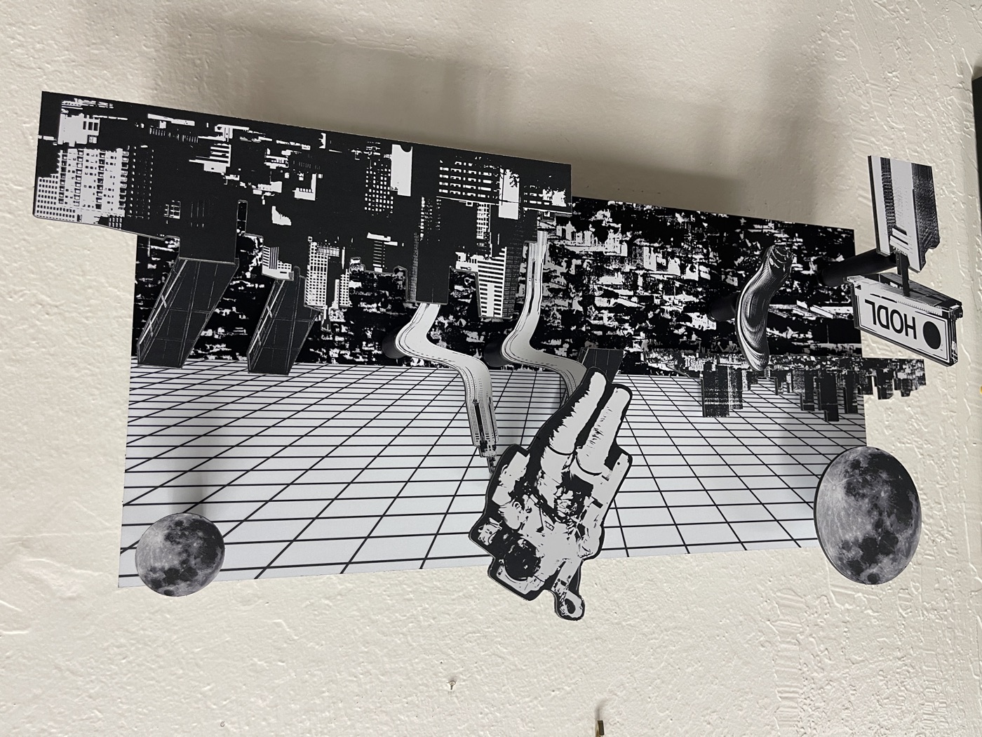 Layout: grid sky, moons at both corners, the HODL billboard off the left edge and the skyline breaking the bottom of the board