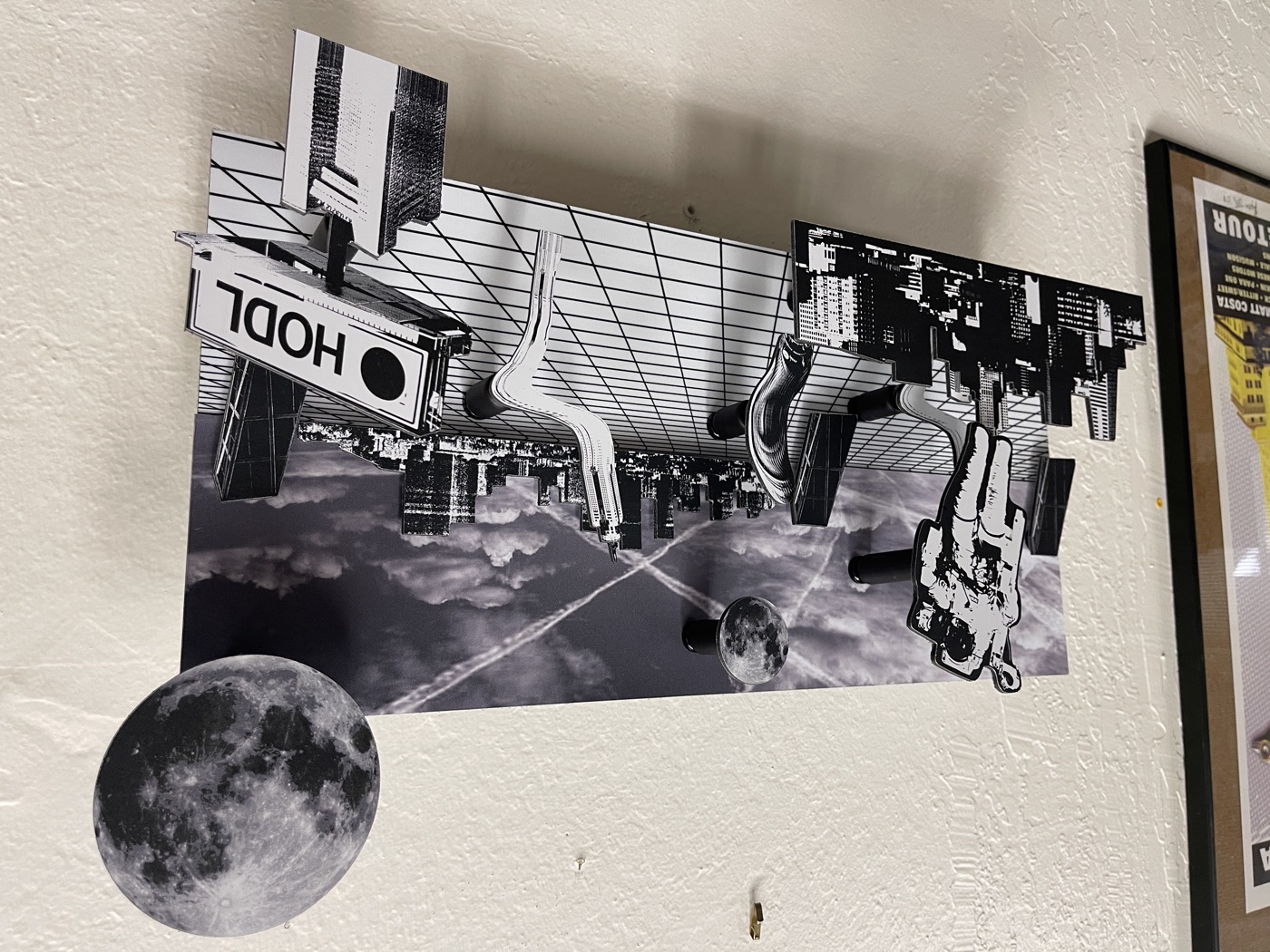 Layout: sky over a grid floor, the astronaut at far left, a big moon breaking the top right corner and the HODL billboard hanging off the right edge