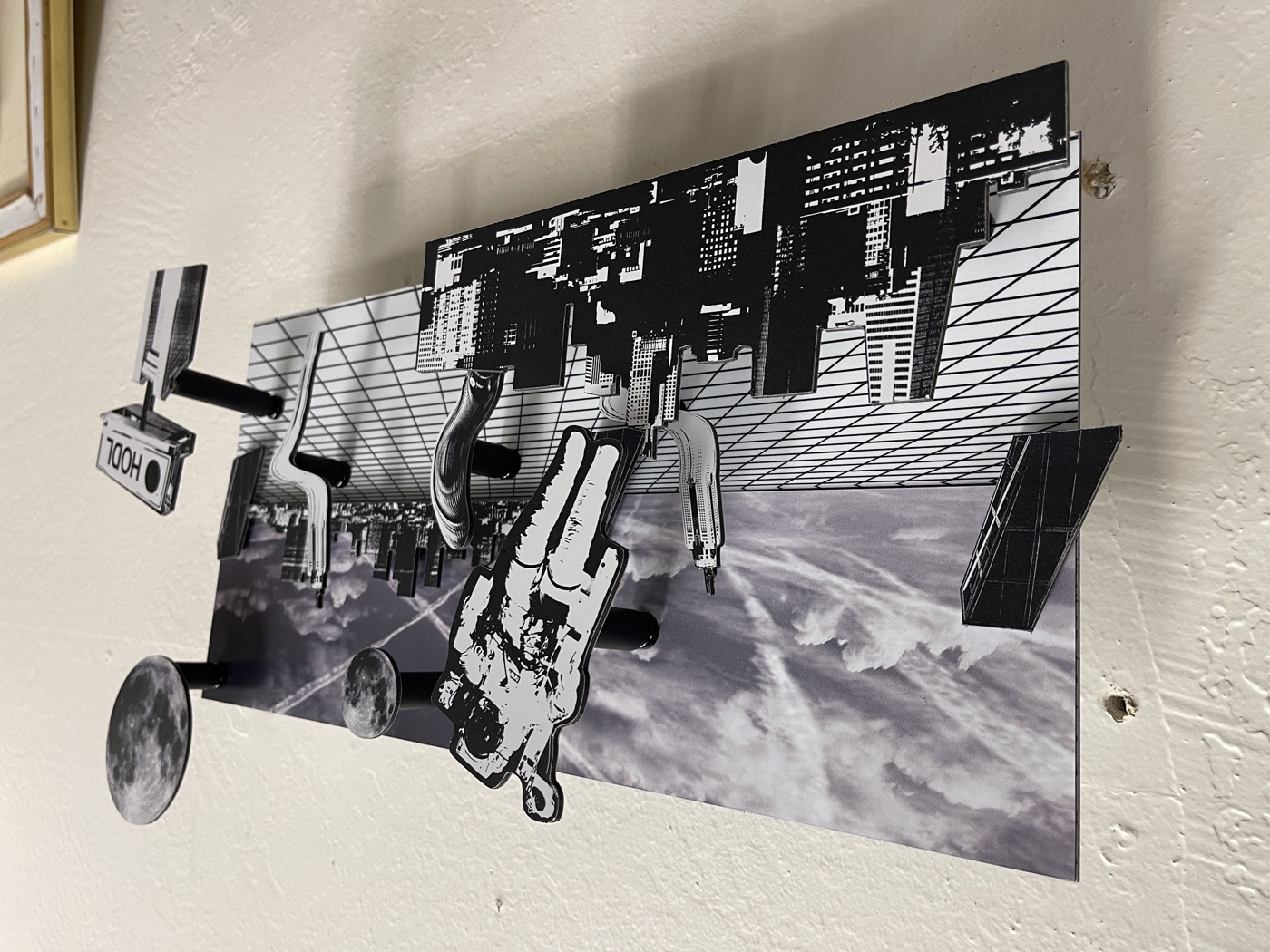 Layout seen from the side: the astronaut, moon and HODL billboard standing off a sky-and-grid board on black magnetic spacers of different lengths